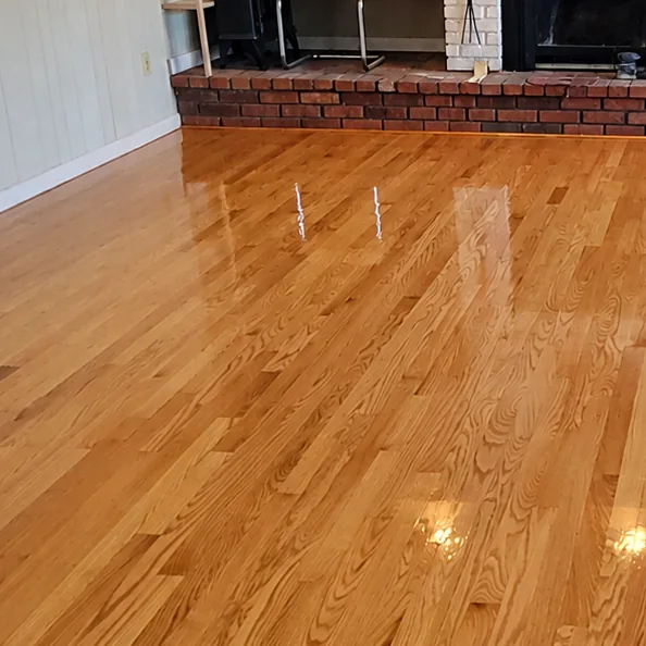 Family room with a brick fireplace, floor restored