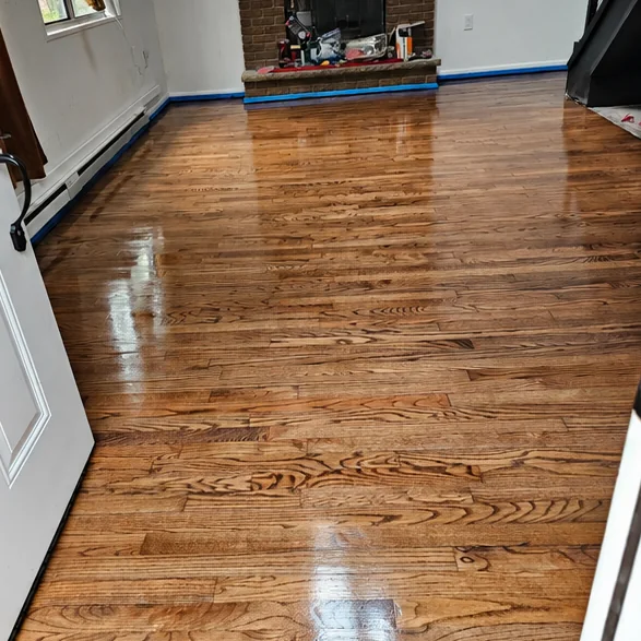 Living room with a brick fireplace, floor restored in dark walnut