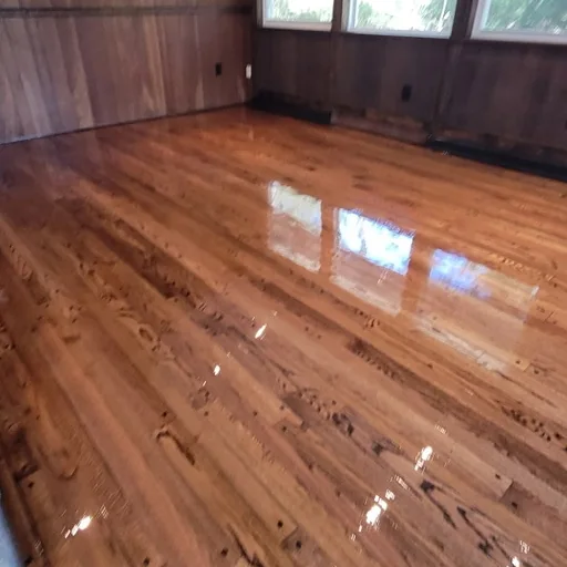 Wood-paneled room, floor restored in dark walnut